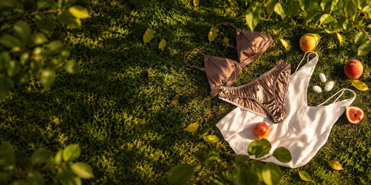 Silk essentials arranged among moss, fruit and flowers